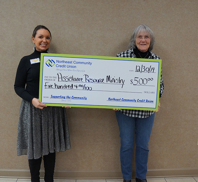 Velda Sizemore, NCCU Member Service Specialist, presents ARM Executive Director Faye Ingram with a donation of $500 for Assistance and Resource Ministries’ programs